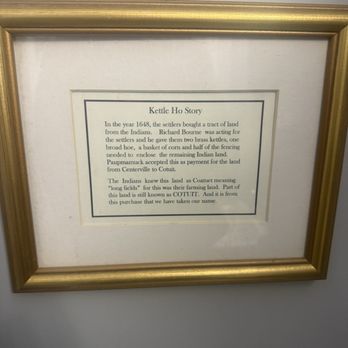 Kettle Ho Restaurant - The history of Kettle Ho Steak House Salad - A framed sign provides the history of Kettle Ho Steak House, including its origins in 1648 and its connection to local land transactions. - Bars Near Me - Cotuit, Massachusetts
