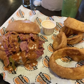 Bad Daddy's Burger Bar - Pastrami Burger* no arugula, add bleu cheese crumbles, side of 4 Steakhouse Onion Rings - Burgers Near Me - Aurora, Colorado Bad Daddy's Burger Bar - Pastrami Burger* no arugula, add bleu cheese crumbles, side of 4 Steakhouse Onion Rings - Burgers Near Me - Aurora, Colorado