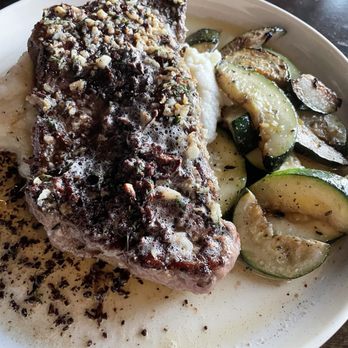 Chef Lino's PRIME - Garlic butter New York steak w mash potatoes and grilled zucchini - Steakhouses Near Me - Bakersfield, California