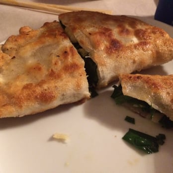Dumpling House - Egg and chive dumplings (half-eaten) yummy. Like scallion pancake with filling - Szechuan Near Me - Milford, Connecticut