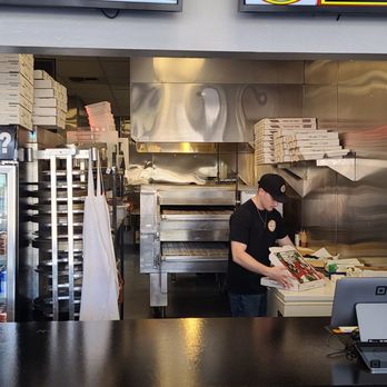 Slicers Pizza - One of the owners at work. - Pizza Near Me - Bakersfield, California Slicers Pizza - One of the owners at work. - Pizza Near Me - Bakersfield, California
