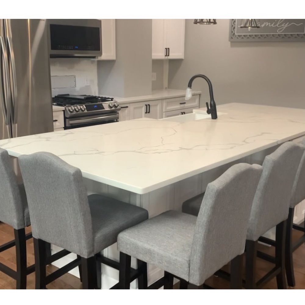 Moore Stone - a kitchen island with chairs and a sink - General Contractors Near Me