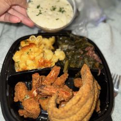 Touch Of Flavor - Shrimp and Fish with a side of grits, greens, mac&cheese.