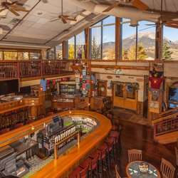 Dillon Dam Brewery - Interior of the Dillon Dam Brewery showing its 2 floors, horseshoe bar and mountain views out of the large windows.