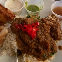 This is 1/2 portion of one of the rice orders, one of the two samosas, about 2/3 portion of Rogan Josh topped with the marinated peppers.