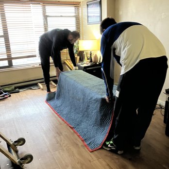 iMOVE NYC - Mike & Vlad in action, finished wrapping the Leather Loveseat - Movers Near Me - Queens, New York