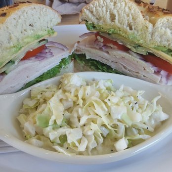 Boardwalk Bagels - Turkey, avocado, and cheese sandwich on an onion bagel with a side of coleslaw. Delicious! - Cafes Near Me - Cypress, California