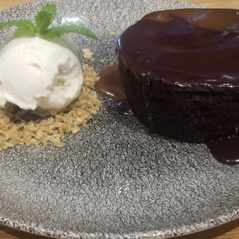 Earls Kitchen + Bar - Sticky toffee pudding w/ caramel and chocolate sauce accompanied by a scoop of delicious creamy vanilla ice cream - New American Near Me - McLean, Virginia Earls Kitchen + Bar - Sticky toffee pudding w/ caramel and chocolate sauce accompanied by a scoop of delicious creamy vanilla ice cream - New American Near Me - McLean, Virginia