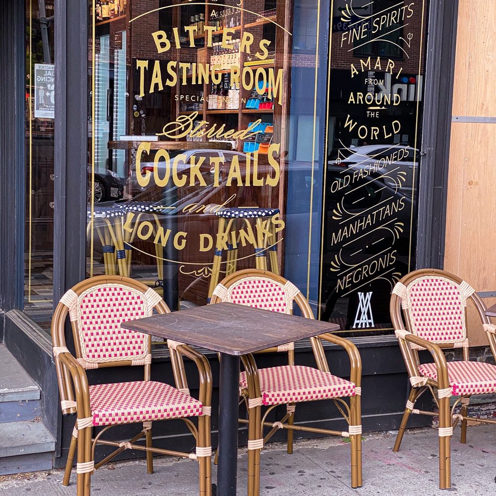Amor y Amargo - a table and chairs outside a restaurant - Cocktail Bars Near Me - New York, New York Amor y Amargo - a table and chairs outside a restaurant - Cocktail Bars Near Me - New York, New York