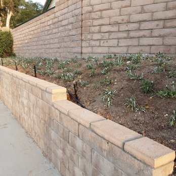 Green Cactus Landscapes - Capped retaining wall planted ground cover - Landscaping Near Me