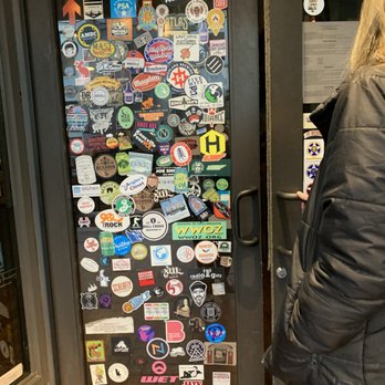 Suttree's High Gravity Tavern - a woman standing in front of a door - Ramen Near Me - Knoxville, Tennessee
