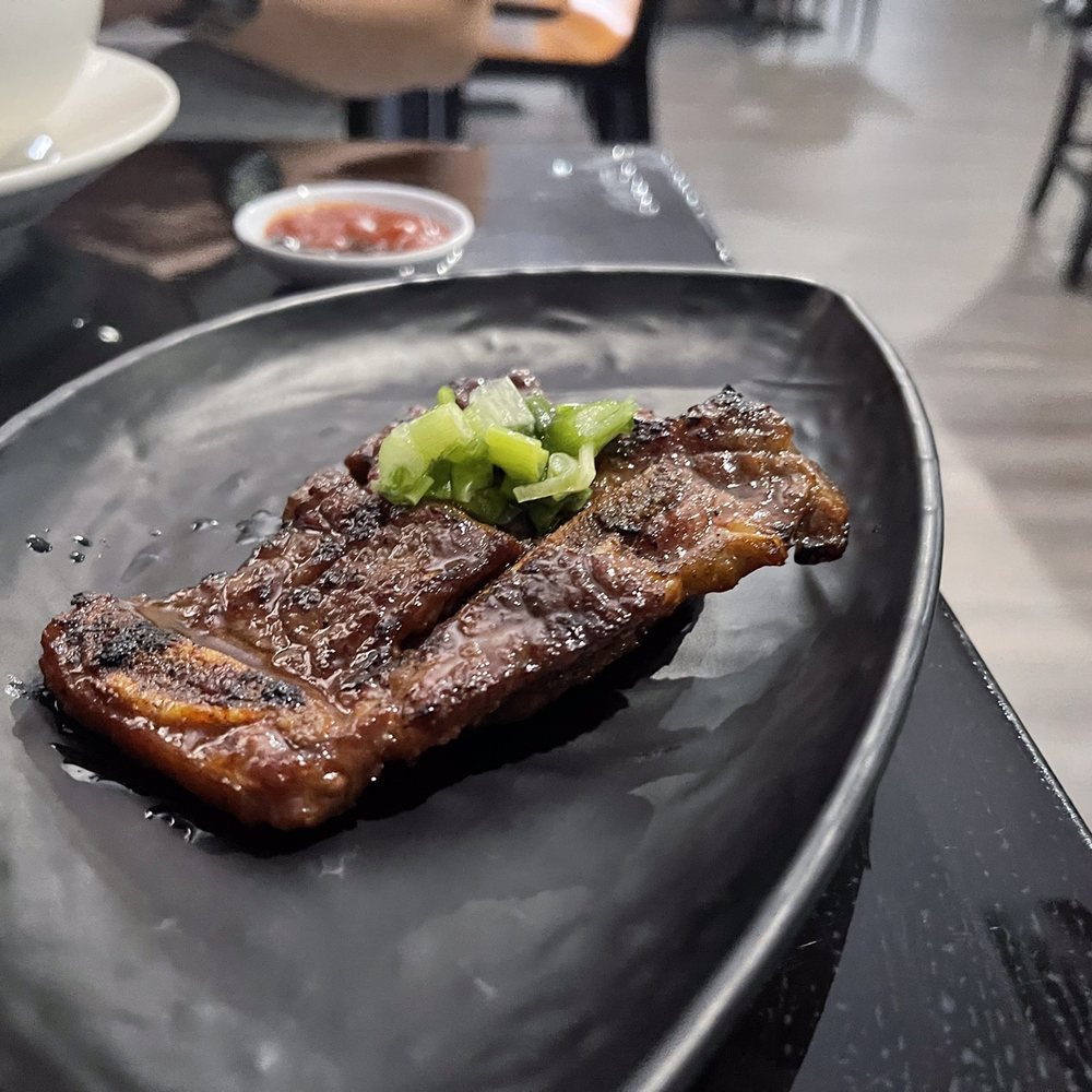 Pho Bosa Kitchen - a steak on a black plate - Vietnamese Near Me - Las Vegas, Nevada Pho Bosa Kitchen - a steak on a black plate - Vietnamese Near Me - Las Vegas, Nevada