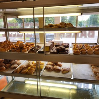 Lupita's Bakery - a variety of baked goods - A bakery display case showcases various baked goods such as muffins, cookies, and pastries, with a view of the outside through the windows. - Bakeries Near Me - Wheeling, Illinois