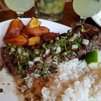 Cuban Pete's - Churrasco (skirt steak) with chimichurri sauce, coconut rice and plantains. And pitcher of pineapple sangria. Heavenly! - Cuban Near Me - Montclair, New Jersey Cuban Pete's - Churrasco (skirt steak) with chimichurri sauce, coconut rice and plantains. And pitcher of pineapple sangria. Heavenly! - Cuban Near Me - Montclair, New Jersey