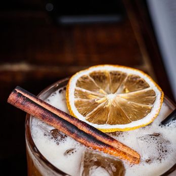 Bar 25 - a drink with a slice of lemon and a cinnamon stick - Mediterranean Near Me - Newburyport, Massachusetts Bar 25 - a drink with a slice of lemon and a cinnamon stick - Mediterranean Near Me - Newburyport, Massachusetts