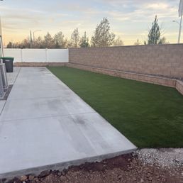 Concrete, turf, retaining wall with rock