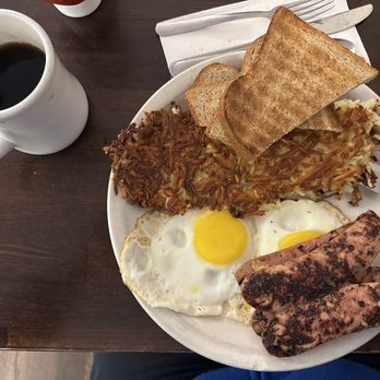 MJ's Downtown Cafe & Bakery - Cup of coffee, 2 eggs sunny-side up, crispy hash browns, toasted wheat bread, & 2 sliced n fried chicken Apple sausages - American Near Me - Brentwood, California MJ's Downtown Cafe & Bakery - Cup of coffee, 2 eggs sunny-side up, crispy hash browns, toasted wheat bread, & 2 sliced n fried chicken Apple sausages - American Near Me - Brentwood, California