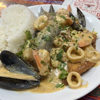 El Rincon Del Sabor - Pescado A La Macho (Fried fish fillets topped with muscles, calamari, shrimp with a special savory sauce. Delicious!!! - Peruvian Near Me - Brockton, Massachusetts El Rincon Del Sabor - Pescado A La Macho (Fried fish fillets topped with muscles, calamari, shrimp with a special savory sauce. Delicious!!! - Peruvian Near Me - Brockton, Massachusetts