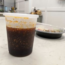 Container of Jang Su Jang's "Yum Yum Sauce" (or was it "Yummy Sauce?"). Sugar, soy sauce, sesame oil, and more. One of JSJ's meat marinades. Container of Jang Su Jang's "Yum Yum Sauce" (or was it "Yummy Sauce?"). Sugar, soy sauce, sesame oil, and more. One of JSJ's meat marinades.