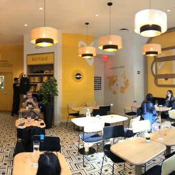 Café Joyeux - Panoramic view of the cafe; love the yellow vibe! - Coffee & Tea Near Me - New York, New York