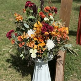 Autumn themed floral arrangement, rented white stand.