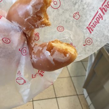 Krispy Kreme - a half eaten doughnut in a wrapper - Donuts Near Me - Springfield, Missouri