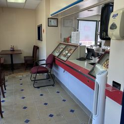 Small counter with food pictures posted