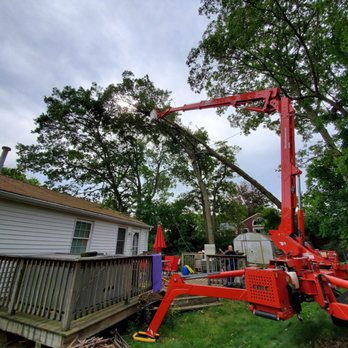 All-Scapes - a man on a cherry picker - Tree Services Near Me - Exeter, Rhode Island