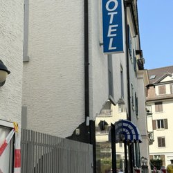 Aparthotel - Hotel from road (Blue Awnings)
