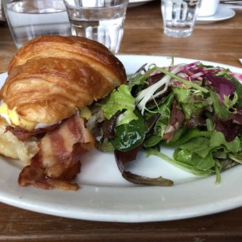Mildred's Temple Kitchen - Bacon Veda's Choice: poached eggs on a flaky croissant with bacon, bearnaise sauce and mixed greens. - Breakfast & Brunch Near Me - Toronto, Ontario Mildred's Temple Kitchen - Bacon Veda's Choice: poached eggs on a flaky croissant with bacon, bearnaise sauce and mixed greens. - Breakfast & Brunch Near Me - Toronto, Ontario