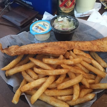 Coconuts On The Beach - Fish and chips are just overflowing the plate. - Bars Near Me - Cocoa Beach, Florida