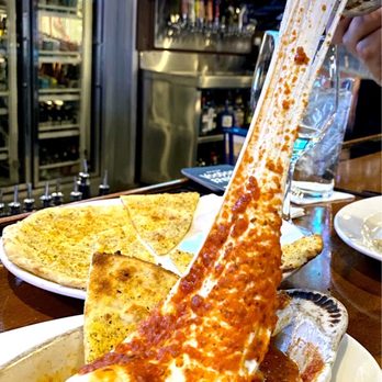 Upper Crust Pizza Patio & Wine Bar - a person grabbing a piece of pizza - Pizza Near Me - Phoenix, Arizona Upper Crust Pizza Patio & Wine Bar - a person grabbing a piece of pizza - Pizza Near Me - Phoenix, Arizona