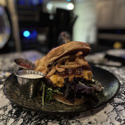 Jack Rose Social Club and Casino - A burger with fries and a side of ketchup and also a side of ranch