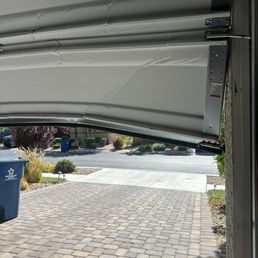 My garage door is bend and the wheels are off the track My garage door is bend and the wheels are off the track