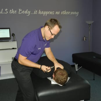 The HIVE Chiropractic Foundation - Dr. Brandon Mahaffy delivery a specific Chiropractic adjustment using the Integrator and Torque Release Technique (TRT). - Chiropractors Near Me - Cornelius, North Carolina