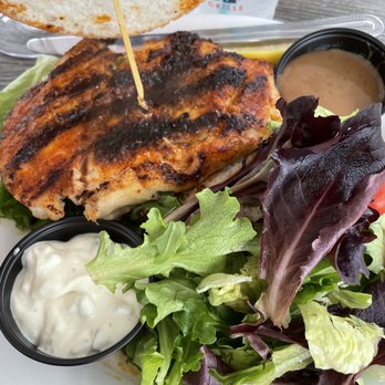 Lock 'N Key Restaurant - Cajun spiced grouper sandwich (on gluten free bun) with side of greens. - Seafood Near Me - Englewood, Florida Lock 'N Key Restaurant - Cajun spiced grouper sandwich (on gluten free bun) with side of greens. - Seafood Near Me - Englewood, Florida