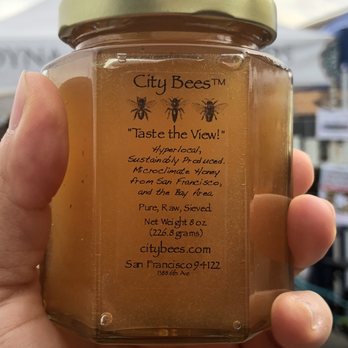City Bees - a hand holding a jar of honey - Specialty Food Near Me City Bees - a hand holding a jar of honey - Specialty Food Near Me