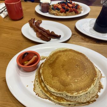 Skillets - Naples - Founders Square - Buttermilk Pancakes in foreground, Waffle w/ Strawberries & Blueberries in background. - Pancakes Near Me - Naples, Florida Skillets - Naples - Founders Square - Buttermilk Pancakes in foreground, Waffle w/ Strawberries & Blueberries in background. - Pancakes Near Me - Naples, Florida