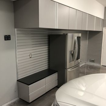 Restore Design Garages - Slat wall and cabinets, notice the lower cabinet, its a shoe rack and bench to site on while putting your shoes on. - Flooring Near Me - Mission Viejo, California
