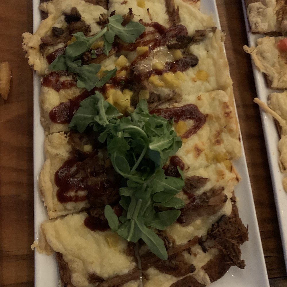Up Rooftop Table and Tavern - Jerk chicken flatbread crisp - Lounges Near Me - Nashville, Tennessee Up Rooftop Table and Tavern - Jerk chicken flatbread crisp - Lounges Near Me - Nashville, Tennessee