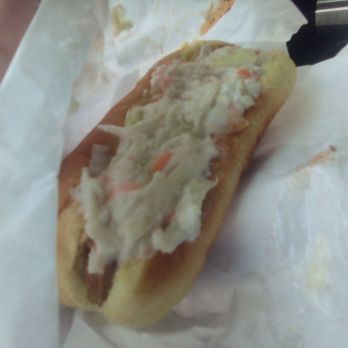 The Grill - a hand holding a hot dog with coleslaw - Beer Bar Near Me - Charleston, West Virginia