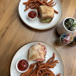 Split chicken sandwich and fries Split chicken sandwich and fries