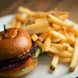 St. Nick's Patio & Grille - The Dasher black bean burger with lettuce, tomato, onion, & mayo on a brioche bun served with fries.