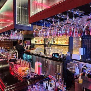 The Ice House - Pasadena - a bar with wine glasses on the bar - Comedy Clubs Near Me - Pasadena, California The Ice House - Pasadena - a bar with wine glasses on the bar - Comedy Clubs Near Me - Pasadena, California