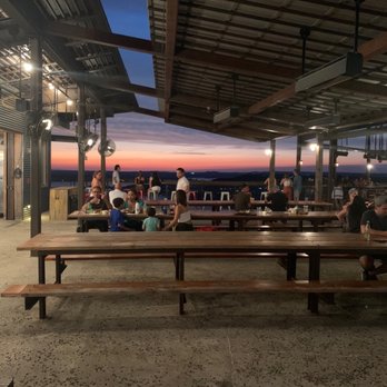 Oasis Texas Brewing - Outside seating with sunset view. - Breweries Near Me - Austin, Texas