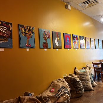 Mildfire Coffee Roasters - coffee bags lined up against a yellow wall - Coffee & Tea Near Me - San Antonio, Texas