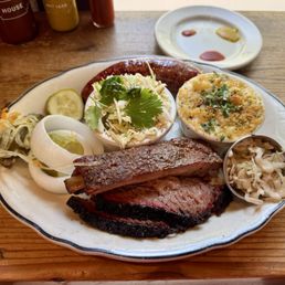 Three BBQ Meats (brisket, ribs, and Texas hot link) with slaw and mac & cheese Three BBQ Meats (brisket, ribs, and Texas hot link) with slaw and mac & cheese