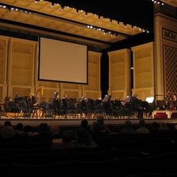 The symphony filing in and tuning up