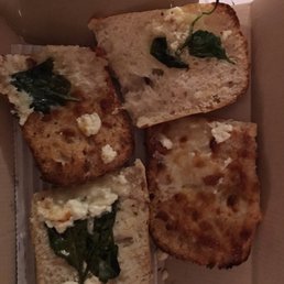 four slices of bread with cheese and spinach four slices of bread with cheese and spinach