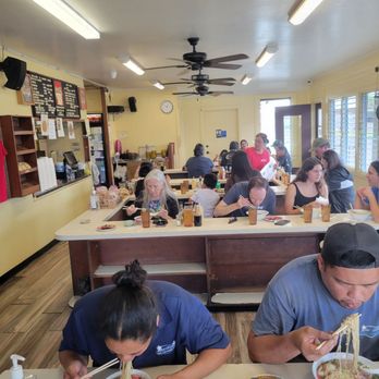Hamura Saimin - Inside the dining room. Family style seating. The lady slurping her soup is the local who showed us how to do it the Hawaiian way. - Japanese Near Me - Lihue, Hawaii Hamura Saimin - Inside the dining room. Family style seating. The lady slurping her soup is the local who showed us how to do it the Hawaiian way. - Japanese Near Me - Lihue, Hawaii